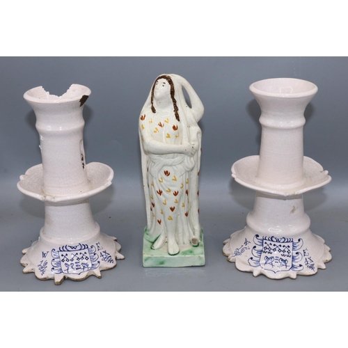 197 - Pair of Delft type candlesticks, H19cm, and a pearlware pottery figure of Hope, H20cm (3) A/F