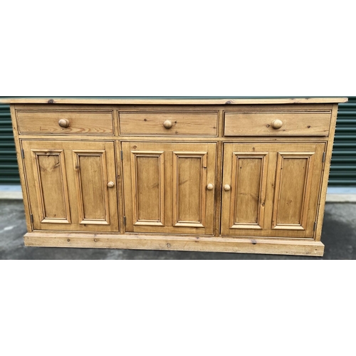 591 - Waxed pine dresser base with three drawers above three twin panel doors with turned wooden handles o... 