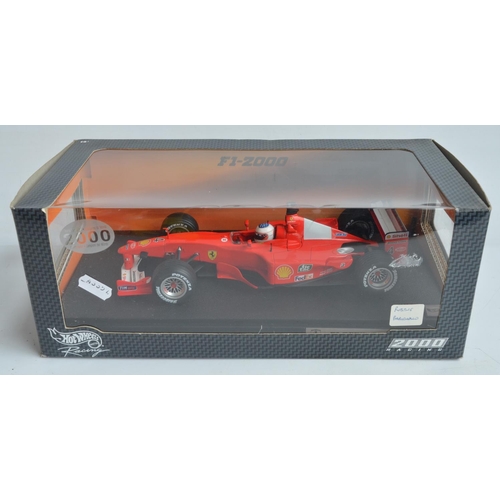 161 - Two 1/18 scale diecast F1 Ferrari F1-2000 models from Hot Wheels Racing with seated driver figures t... 