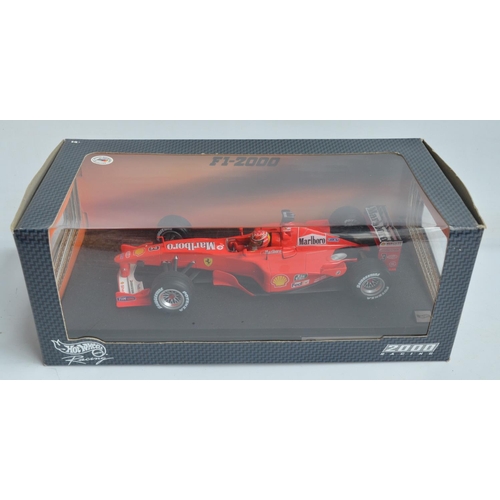 161 - Two 1/18 scale diecast F1 Ferrari F1-2000 models from Hot Wheels Racing with seated driver figures t... 