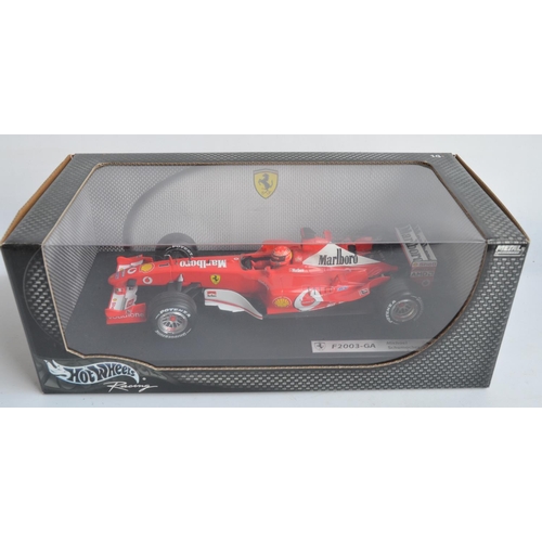 162 - Two 1/18 scale diecast Michael Schumacher F1 Ferrari models from Hot Wheels Racing with seated drive... 