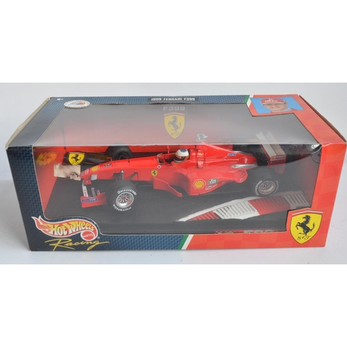 162 - Two 1/18 scale diecast Michael Schumacher F1 Ferrari models from Hot Wheels Racing with seated drive... 