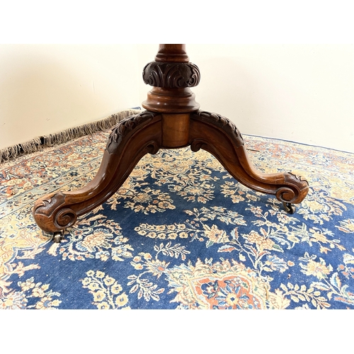 455 - Victorian figured walnut breakfast table, circular top on carved column and three cabriole legs, D11... 