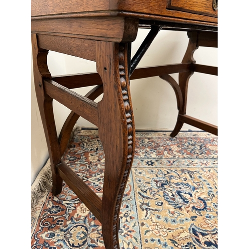 484 - Victorian oak rectangular writing table, with frieze drawer and slide, on carved scroll supports, W8... 