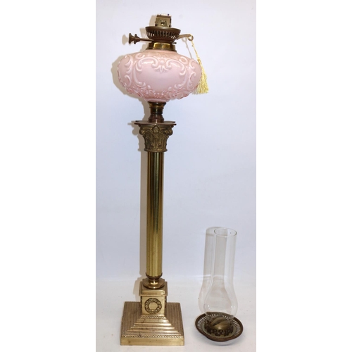 140 - Early C20th brass Corinthian column oil lamp on stepped base, moulded pink opaline glass reservoir, ... 