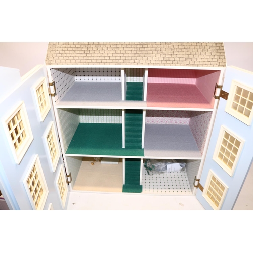 235 - Modern three-storey six-room dolls house, and a collection of dolls and dolls house furniture (qty)