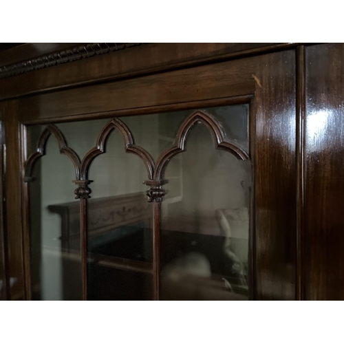 616 - C19th mahogany side cabinet, with lobed cornice above a pair of gothic moulded glazed doors, the bas... 