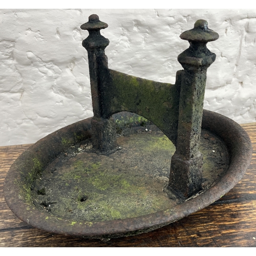 130 - Black painted cast iron boot scraper on oval base, L35cm