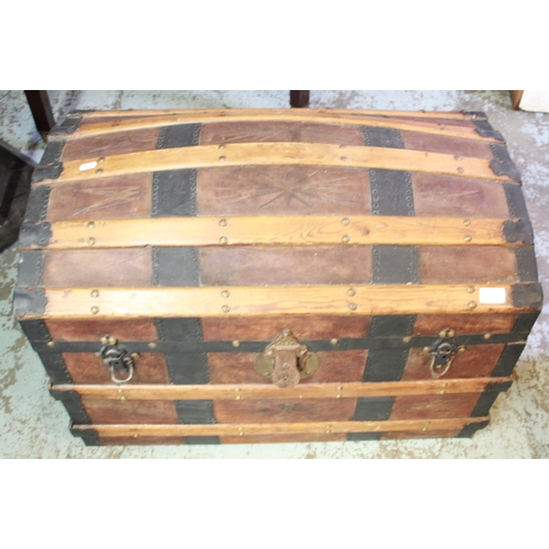 1329 - Black painted strong box and a wooden banded and studied sea chest