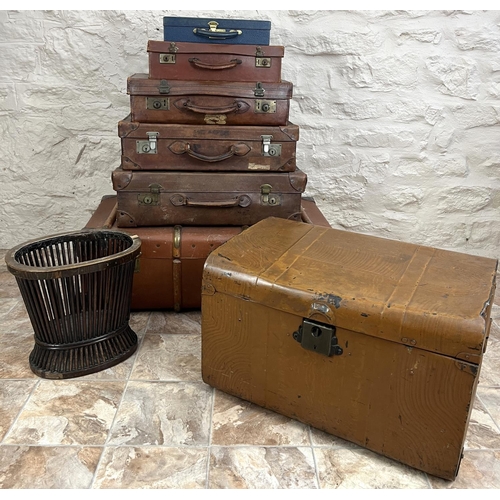 347 - Collection of suitcases, scumbled tin trunk, an initialed wood bound trunk, and a waste paper basket... 