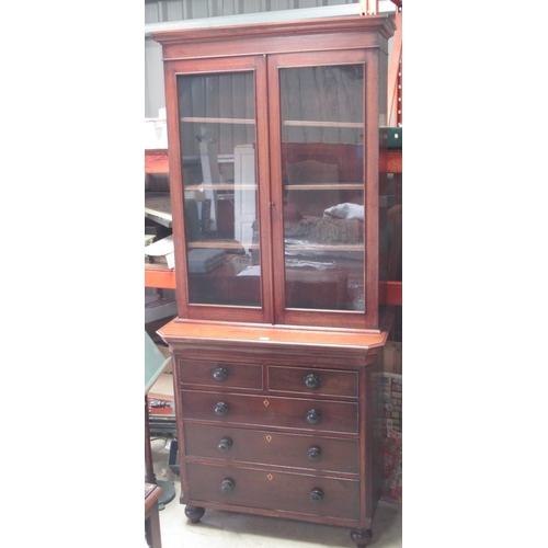 566 - Victorian oak and mahogany bookcase on chest, with two glazed doors above two short and three long g... 