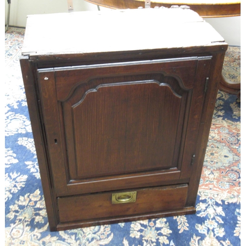 483 - C18th and later oak wall cupboard, fielded arched panel door above a drawer, W57cm D33cm H73cm