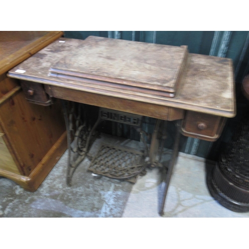 692 - Singer sewing machine table with fold out machine and cast metal base