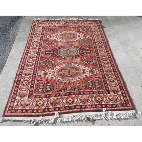 503 - C20th Caucasian pattern wool rug, three central medallions in orange ground field within repeating g... 