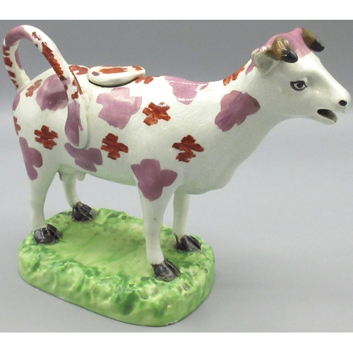 1166 - Early C19th Cambrian Pottery cow creamer, the pink lustre and red enamel spotted animal standing on ... 