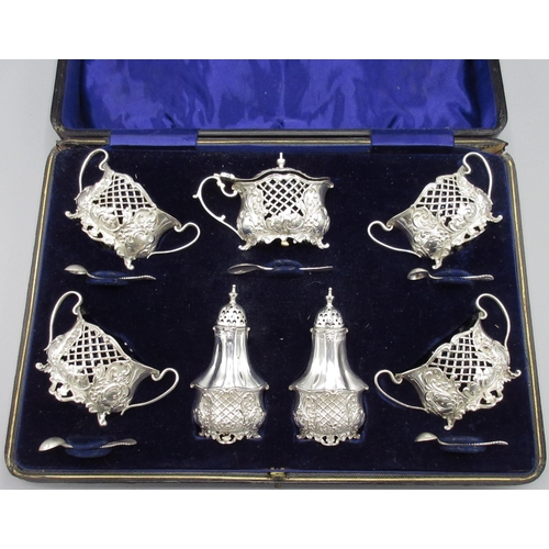 1052 - Edward VII silver Rococo Revival seven-piece cruet set, decorated with scrolls, pierced and cross ha... 