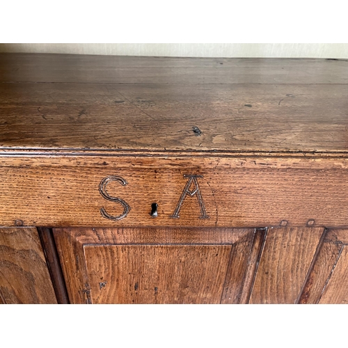 1350 - George III oak coffer, hinged plank top with moulded edge above four fielded panel front, carved wit... 