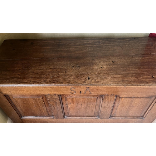 1350 - George III oak coffer, hinged plank top with moulded edge above four fielded panel front, carved wit... 