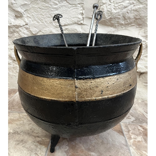 1177 - Cast iron cauldron, with two handles and on three feet, later black painted with gold band, D37cm H3... 