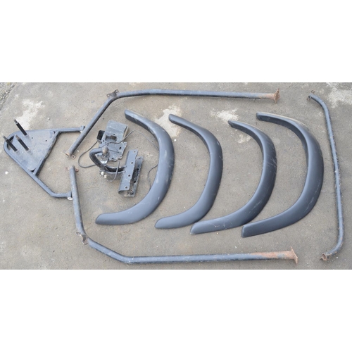 251 - Collection of Land Rover Defender spare parts to include a set of ABS wheel arches, a steel roll cag... 