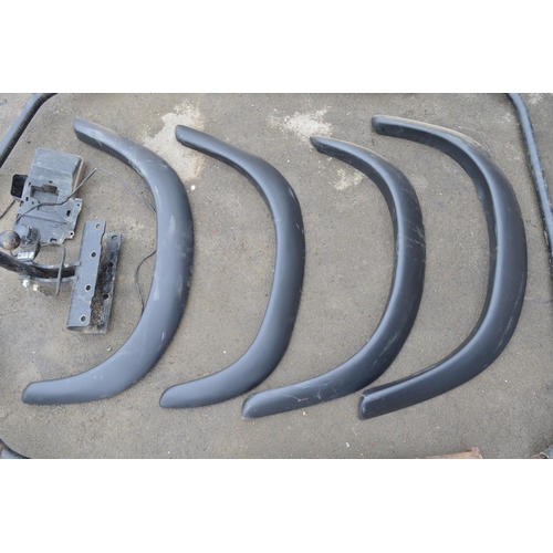 251 - Collection of Land Rover Defender spare parts to include a set of ABS wheel arches, a steel roll cag... 