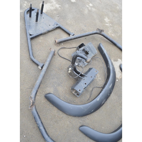 251 - Collection of Land Rover Defender spare parts to include a set of ABS wheel arches, a steel roll cag... 