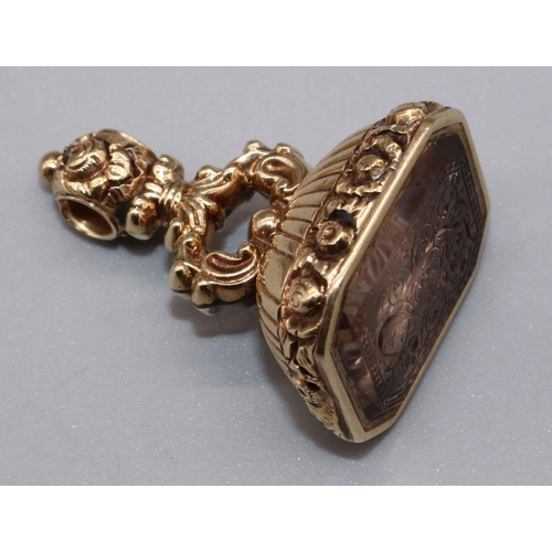 1029 - Victorian yellow metal fob seal set with quartz intaglio with carved foliage detail, 21.00g