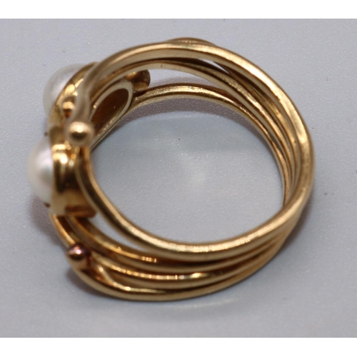 1021 - Yellow metal ring by Susan Wright, set with two pearls in open abstract wirework band, no visible ha... 