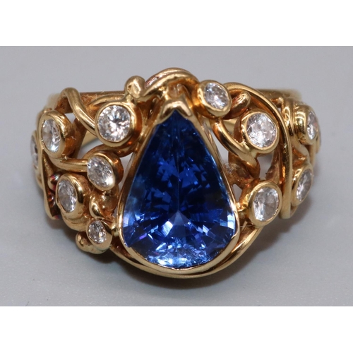1001 - 18ct yellow gold sapphire and diamond ring by Susan Wright, set with central pear cut sapphire, on w... 