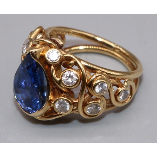 1001 - 18ct yellow gold sapphire and diamond ring by Susan Wright, set with central pear cut sapphire, on w... 