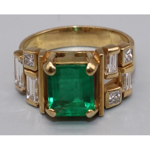 1003 - 18ct yellow gold diamond and emerald ring by Susan Wright, the central emerald cut emerald in claw s... 