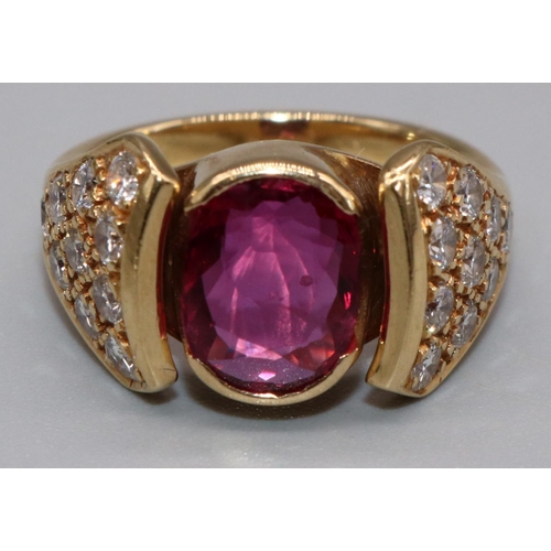 1006 - 18ct yellow gold diamond and ruby ring by Susan Wright, the central oval cut ruby in split bezel mou... 