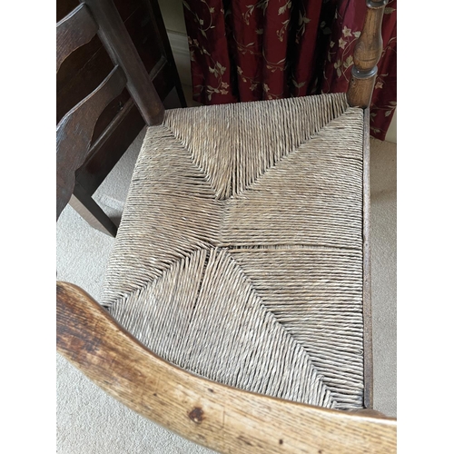 1352 - Early 19th century ash and elm Lancashire ladderback elbow chair, with shaped top rail, flattened cu... 