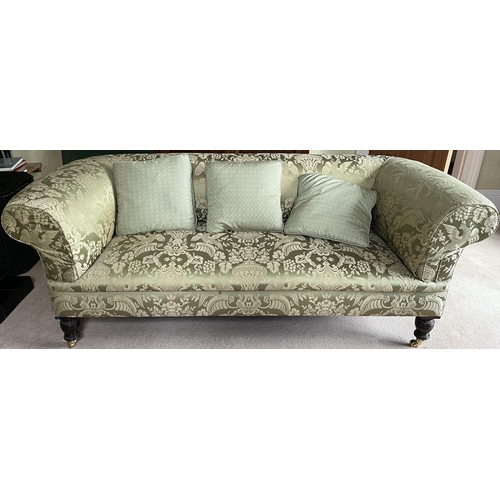 1320 - Victorian style Chesterfield sofa, with outsplayed arms on turned supports with brass sockets and ba... 