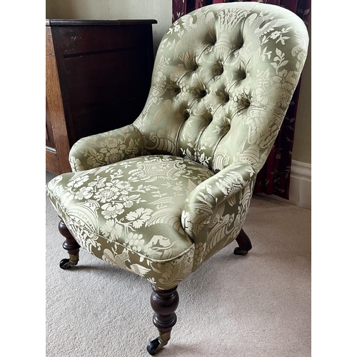 1333 - Victorian nursing chair, buttoned back, low arms and serpentine seat on turned supports, brass socke... 