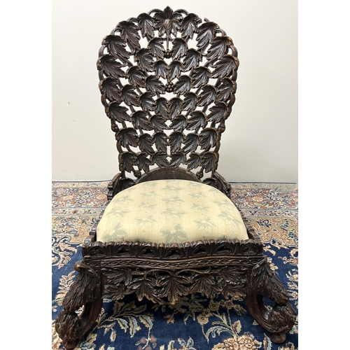 1356 - 19th century Eastern hardwood nursing chair, curved back and frieze pierced and carved with profuse ... 