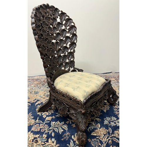 1356 - 19th century Eastern hardwood nursing chair, curved back and frieze pierced and carved with profuse ... 