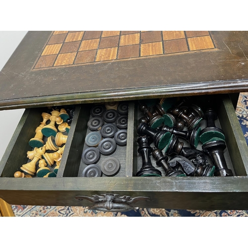 1337 - Art Nouveau Liberty style green stained games table, moulded square top inlaid for chess, fretwork f... 