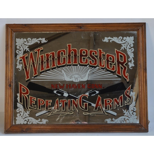 132 - Two decorative mirrors to include Dewar's Scotch Whiskey (81.7x64cm) and Winchester Repeating Arms (... 