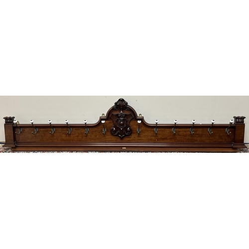 1321 - Large Victorian Country House mahogany coat rack, with carved shield cresting, twelve brass hooks wi... 