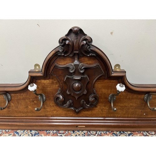 1321 - Large Victorian Country House mahogany coat rack, with carved shield cresting, twelve brass hooks wi... 