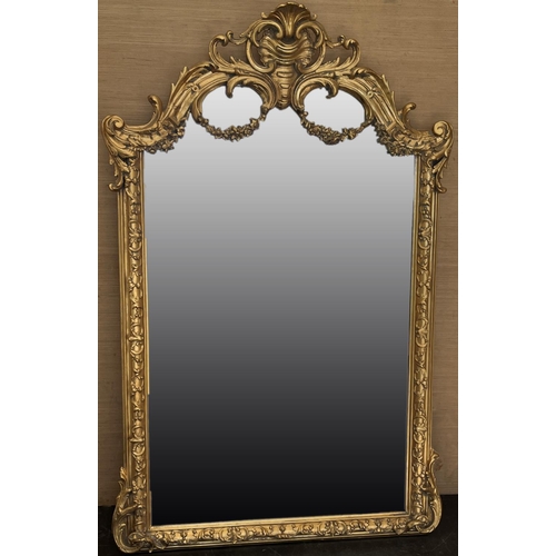 1322 - Large Rococo Revival gilt wall mirror, upright plate in C scroll moulded frame with swag and shell c... 