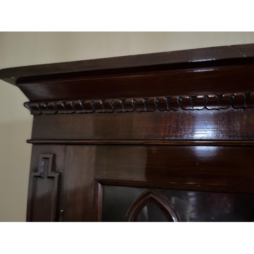 1299 - C19th mahogany side cabinet, lobed cornice above a pair of gothic moulded glazed doors, the base wit... 