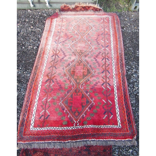 1295 - Caucasian red ground multicoloured rug, with quadruple hooked lozenge medallion field in repeating b... 