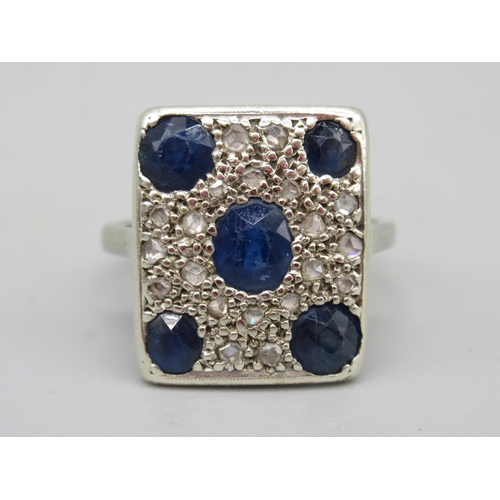 11 - 9ct white gold sapphire and diamond ring, the rectangular face set with central oval cut sapphire, a... 