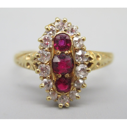 19 - 18ct yellow gold ring set with three brilliant cut red spinels surrounded by diamonds, on ornate sho... 