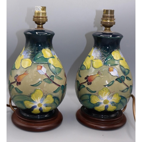 Moorcroft Pottery: pair of 'Hypericum' pattern table lamp bases, yellow flowers on graduated blue to green ground, H27cm incl. electrical fitting (2)