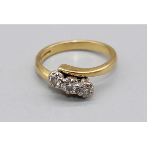 49 - 18ct yellow gold cross over three stone diamond ring, the diamonds illusion set, stamped 750, size L... 