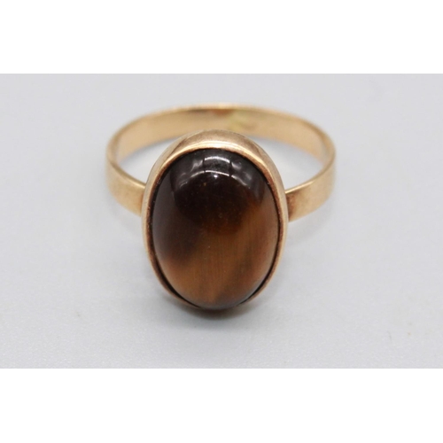 53 - 18ct yellow gold cabochon tigers eye ring, stamped 750, size L, 3.8g