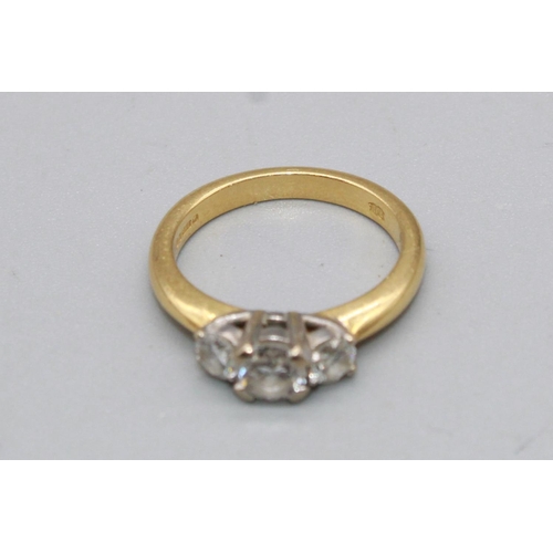 63 - 18ct yellow gold three stone diamond ring set with a large central diamond flanked by two smaller di... 